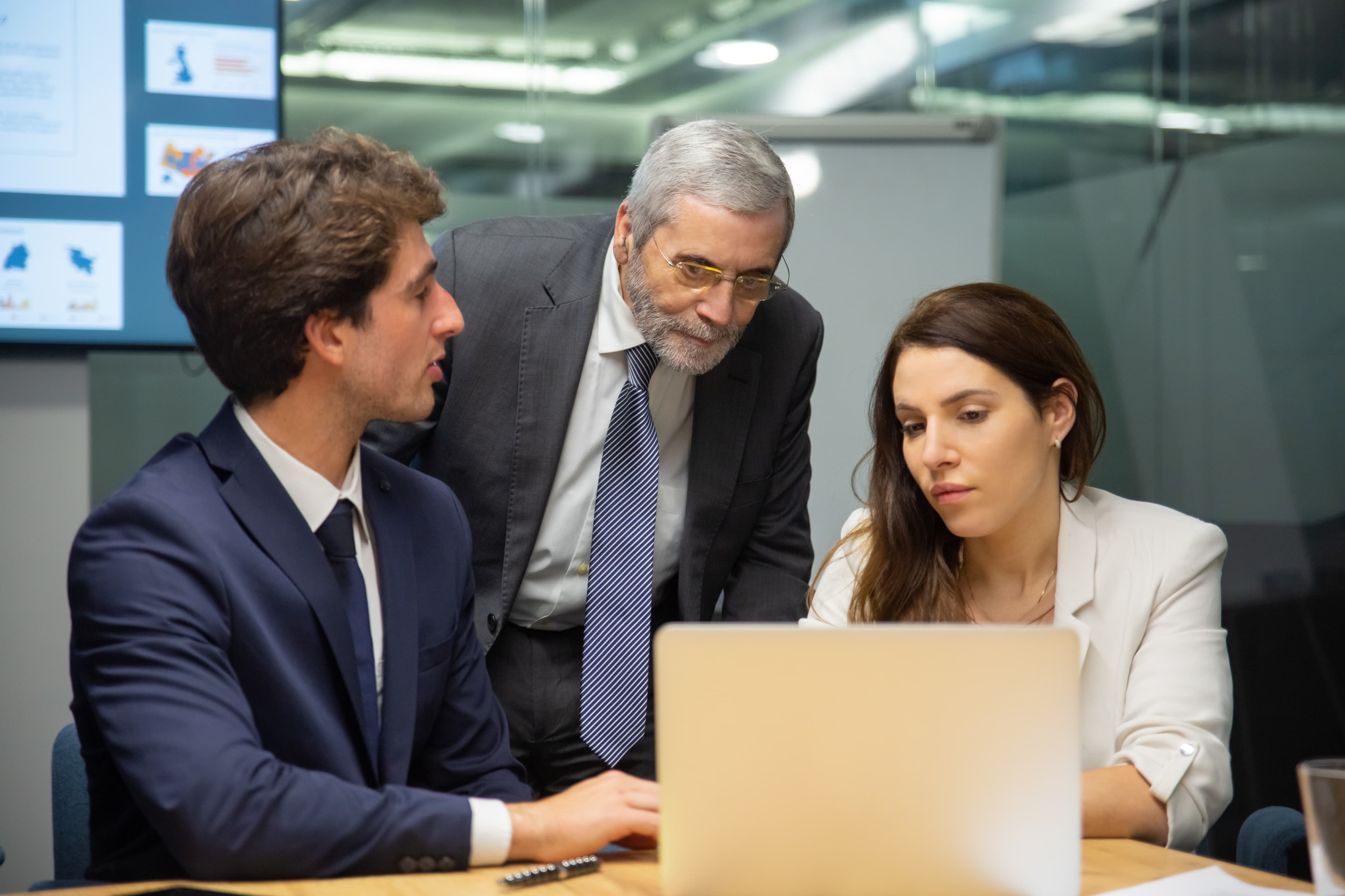 Senior advisors reviewing laptop